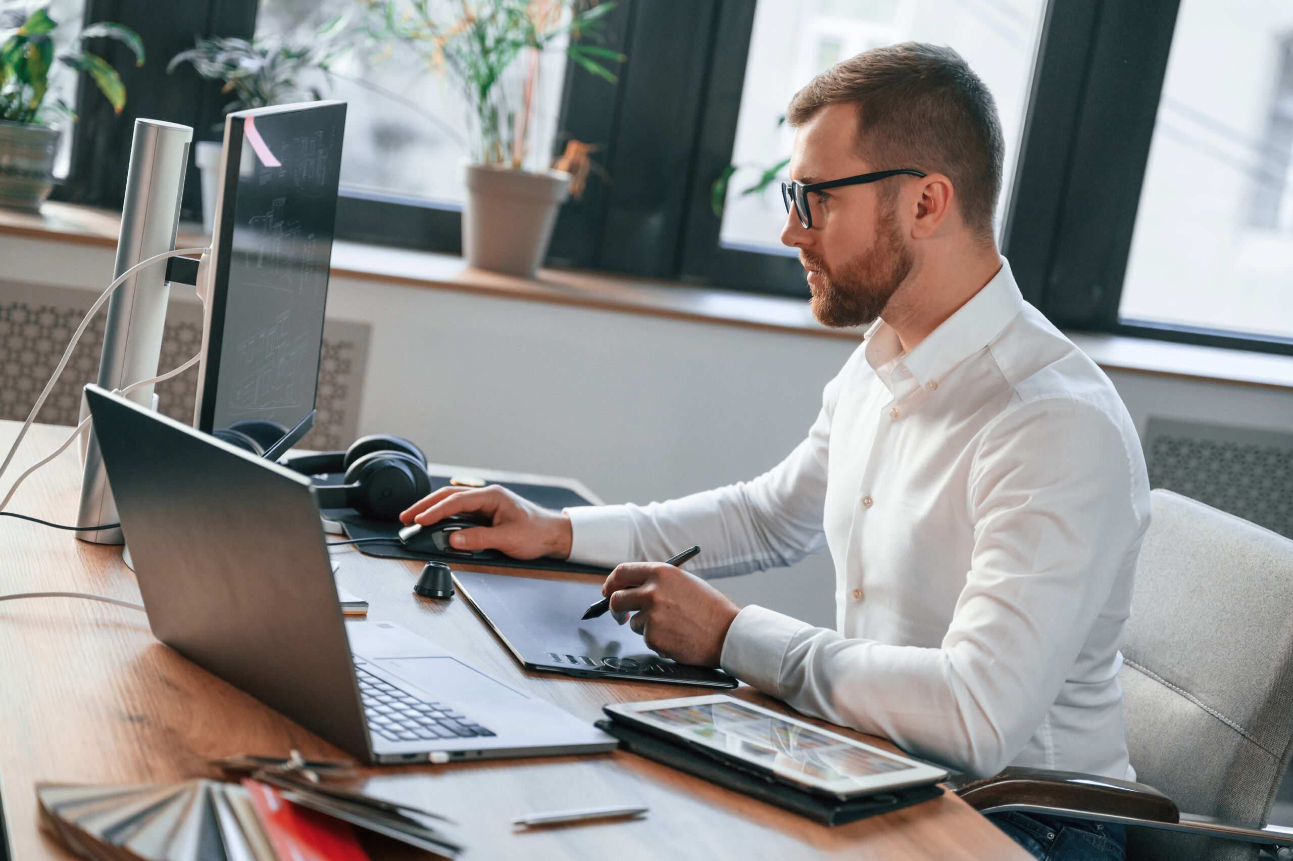 Professional reviewing information at a laptop in a modern office